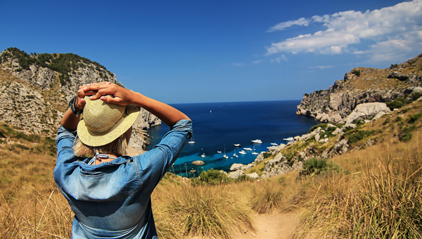 Woman with hat and jacket escaping her technology addiction by being out in nature