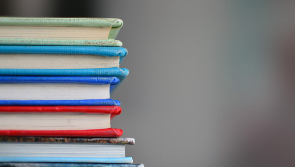 Five books stacked on top of each other - where to donate books