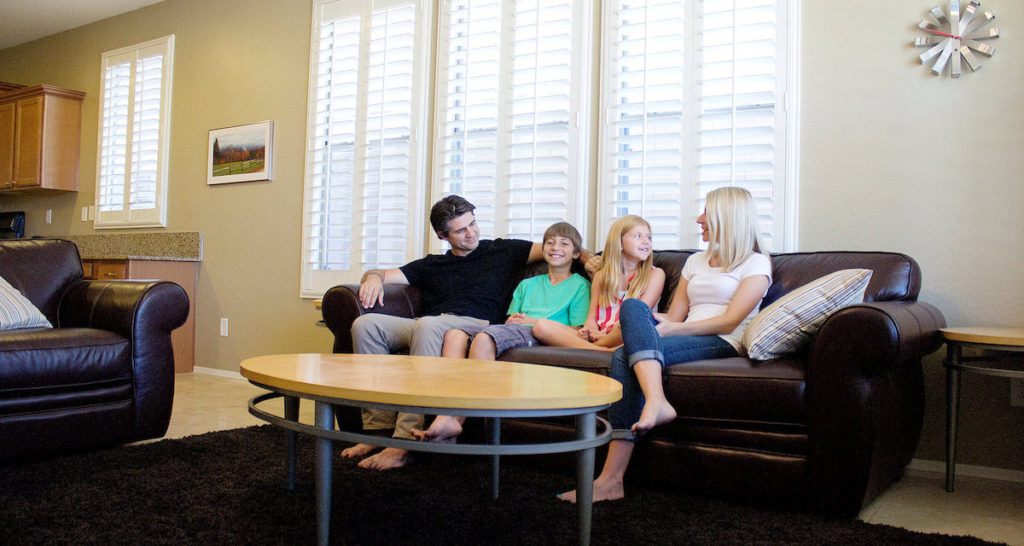 Joshua Becker and his minimalist family sitting on their couch